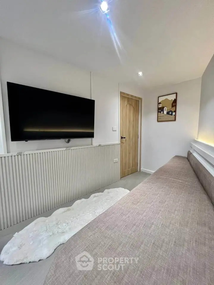 Modern living room with sleek TV and cozy seating