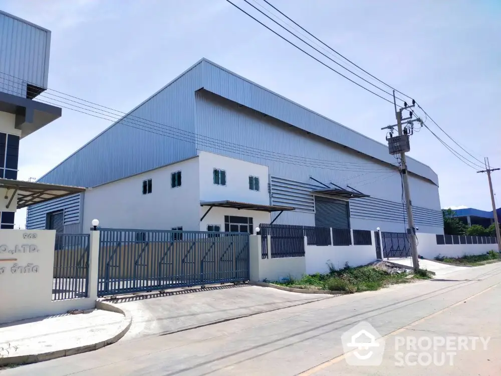 Spacious industrial warehouse with secure gated entrance and modern design.