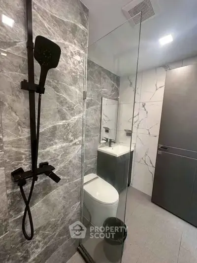 Modern bathroom with sleek shower and elegant marble tiles