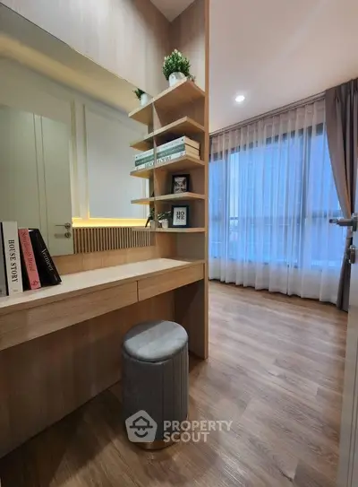 Modern study nook with built-in shelves and elegant decor in a bright apartment.