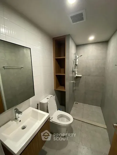 Modern bathroom with sleek fixtures and spacious shower area