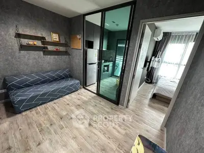 Modern apartment interior with open layout, featuring a cozy living room and sleek kitchen design.