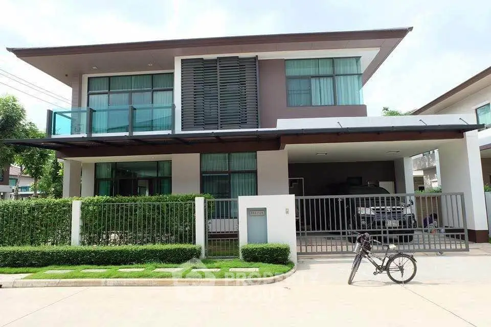 Modern two-story house with sleek design, large windows, and a spacious driveway in a serene neighborhood.