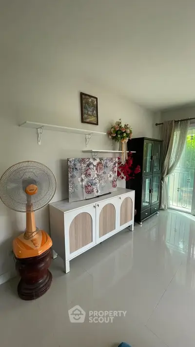 Bright living room with modern decor and balcony view