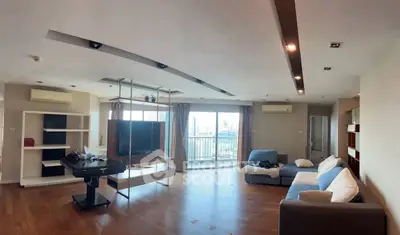 Spacious modern living room with city view and stylish furnishings.