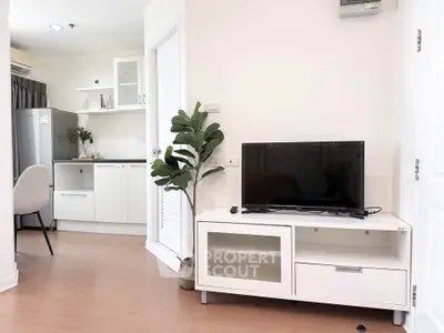 Modern living room with sleek TV stand and view into a stylish kitchen, perfect for urban living.