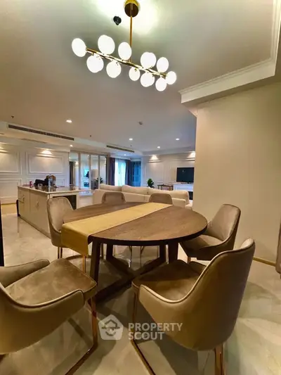 Luxurious open-plan living room with elegant dining area and modern lighting