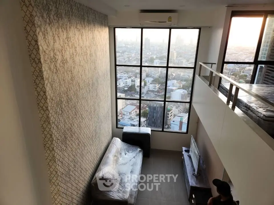 Stunning loft apartment with floor-to-ceiling windows offering breathtaking city views and modern interior design.