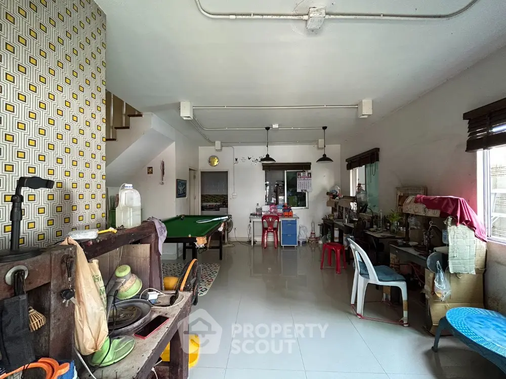 Spacious living area with unique decor and ample natural light