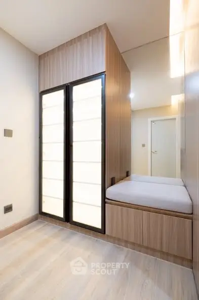 Modern minimalist hallway with built-in storage and sleek lighting