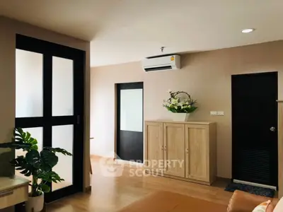 Modern living room with sleek design and air conditioning unit