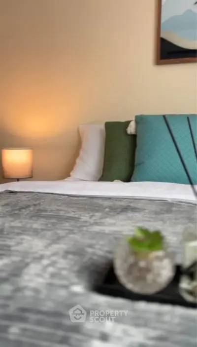 Cozy bedroom with stylish decor and soft lighting, perfect for relaxation.