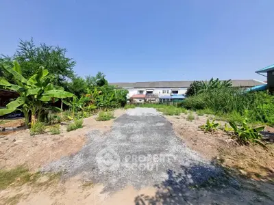 Spacious plot of land with lush greenery and clear blue sky, ideal for development opportunities.