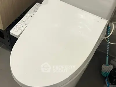 Modern bathroom with high-tech bidet toilet and sleek design.