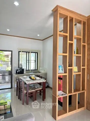 Modern kitchen with wooden partition and dining area in stylish home