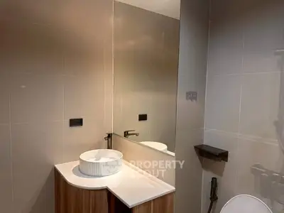 Modern bathroom with sleek vanity and large mirror