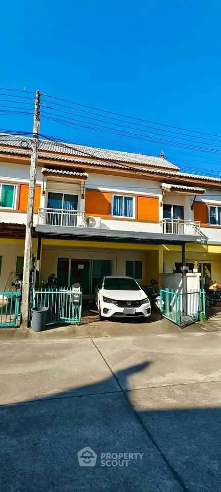 Charming two-story townhouse with carport and balcony in sunny neighborhood