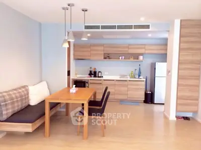 Modern kitchen with open layout and cozy dining area in stylish apartment.