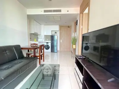 Modern living room with sleek furniture and in-unit laundry in a stylish apartment.