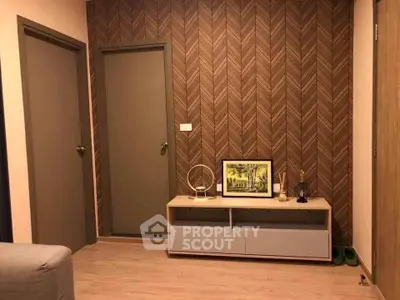 Stylish modern interior with patterned wallpaper and sleek console table in cozy living space.