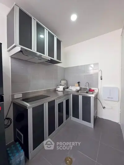Modern kitchen with sleek cabinetry and stainless steel appliances in a compact layout.