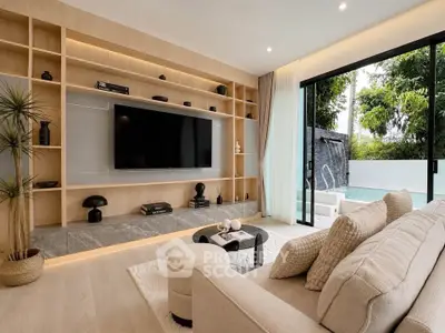 Luxurious living room with modern decor and pool view, featuring elegant shelving and cozy seating.