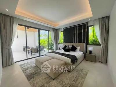 Luxurious bedroom with modern decor and private patio access, featuring elegant furnishings and natural light.