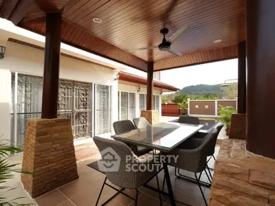 Charming outdoor patio with elegant dining set and scenic view, perfect for entertaining guests.