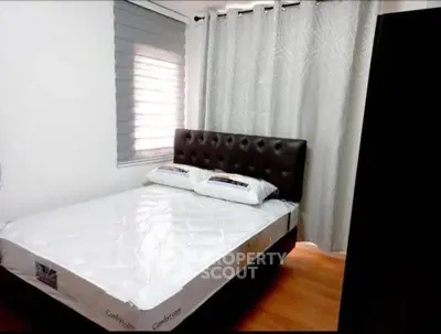 Cozy bedroom with modern decor and comfortable bed in a stylish apartment.