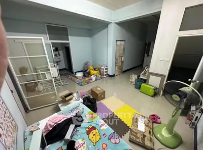 Spacious bedroom with playful decor and ample storage space, ideal for family living.