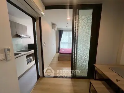 Modern apartment with open kitchen and cozy bedroom, ideal for urban living.