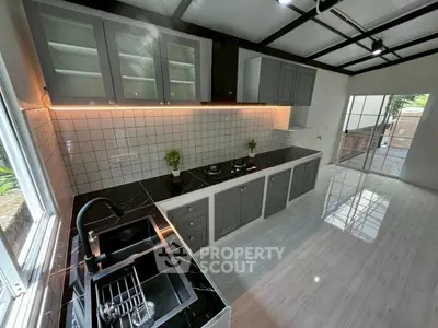 Modern kitchen with sleek black countertops and open layout design