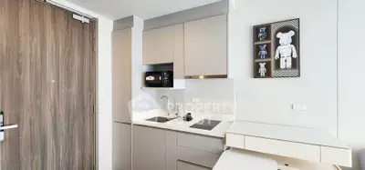 Modern kitchen with sleek cabinetry and integrated appliances in a stylish apartment.