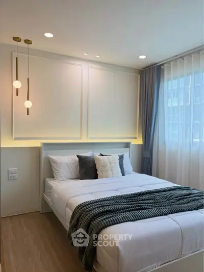 Modern bedroom with elegant lighting and cozy decor in a stylish apartment.