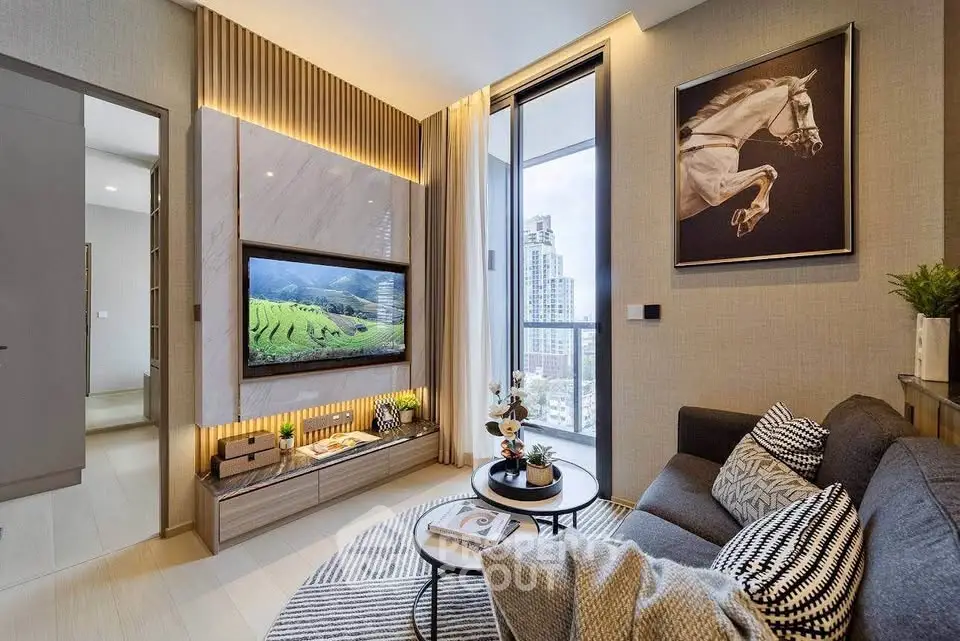 Modern living room with city view, stylish decor, and cozy seating area.