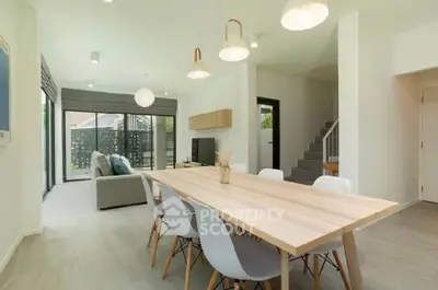 Modern open-plan living and dining area with stylish furniture and natural light.