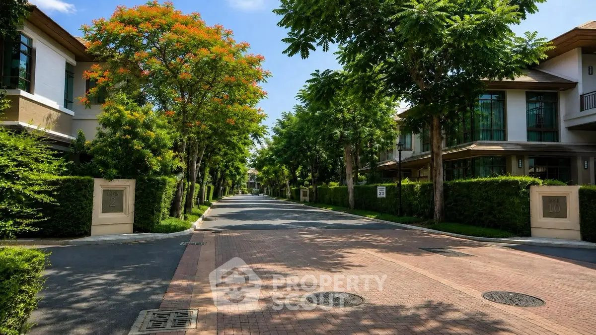 Luxurious residential street lined with modern homes and lush greenery, offering serene and upscale living environment.