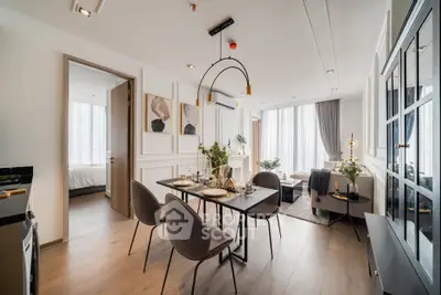 Luxurious open-plan living and dining area with elegant decor and natural light.