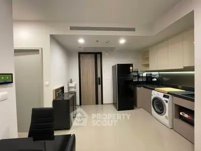 Modern kitchen with sleek appliances and open layout in a contemporary apartment.