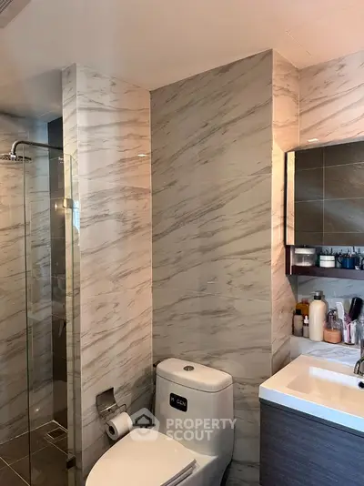 Modern bathroom with marble walls and sleek fixtures