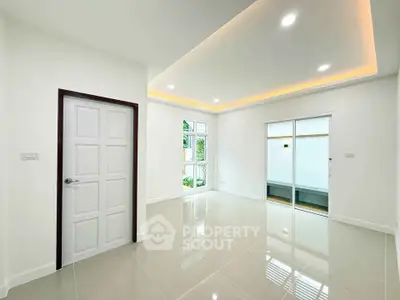 Modern minimalist living room with glossy tile flooring and recessed lighting