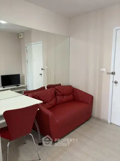 Cozy living room with red sofa and wall mirror in modern apartment