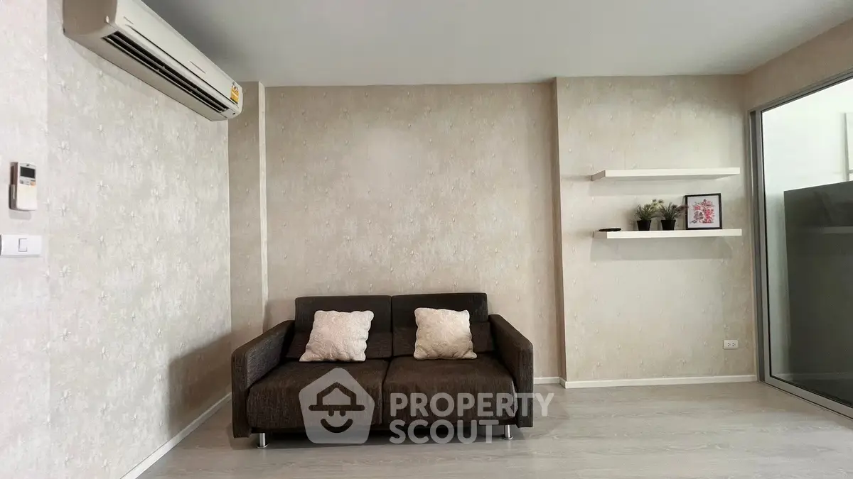 Modern living room with sleek sofa and wall-mounted air conditioner