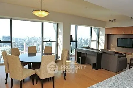 Spacious living room with panoramic city views and elegant dining area.