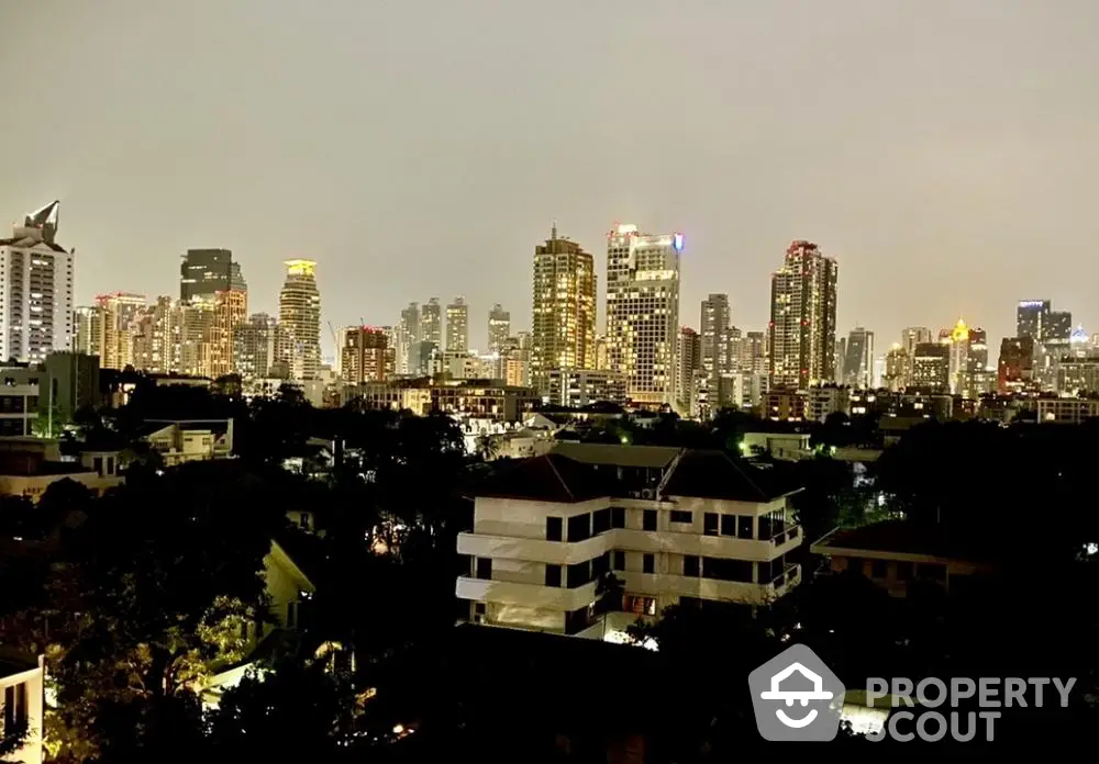 Stunning city skyline view from a high-rise apartment balcony at dusk, showcasing urban living.