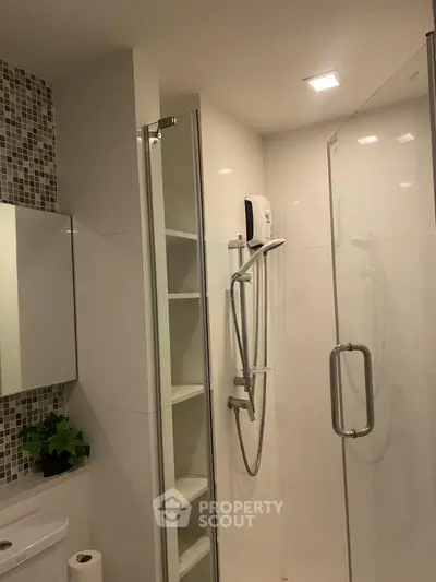 Modern bathroom with glass shower enclosure and sleek tile design