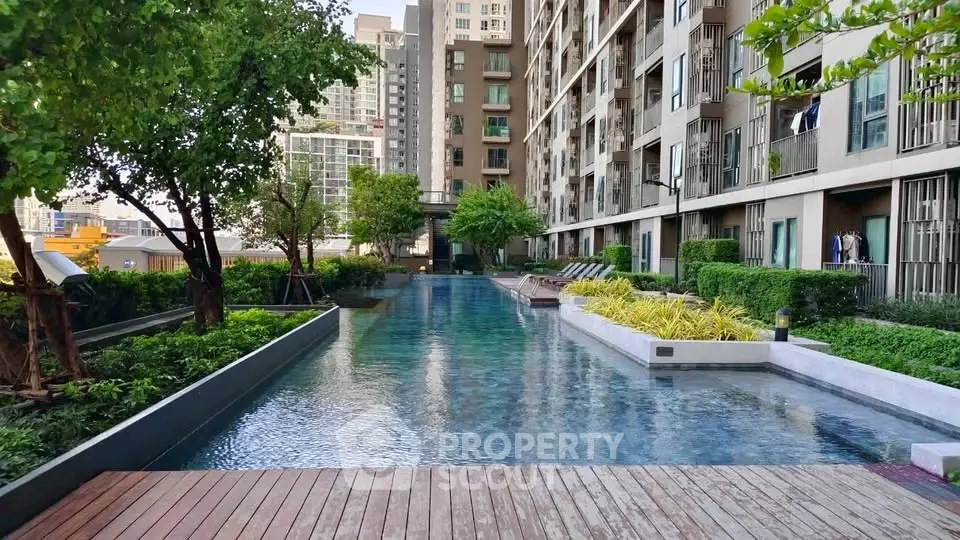 Luxurious apartment complex with stunning pool and lush greenery