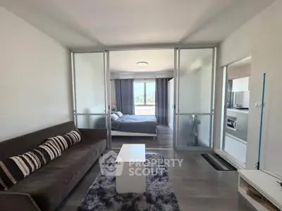 Modern apartment interior with sliding glass doors, cozy living room, and stylish bedroom.