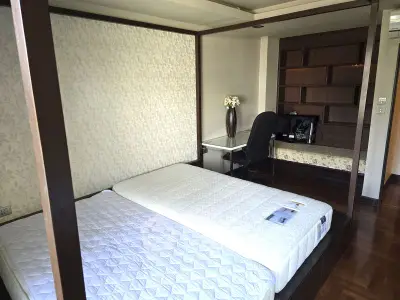 Spacious bedroom with modern decor and built-in shelving