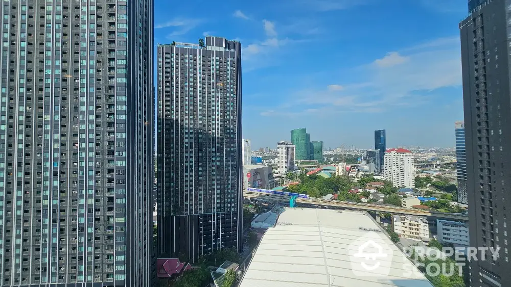 Stunning cityscape view with modern high-rise buildings and clear blue sky.